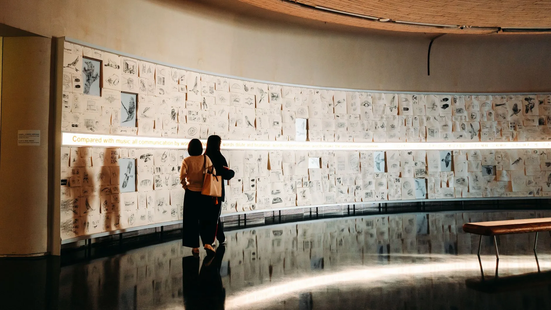A dimly lit room with an intricate projection on crumbling brick walls, showcasing projection mapping for immersive spac