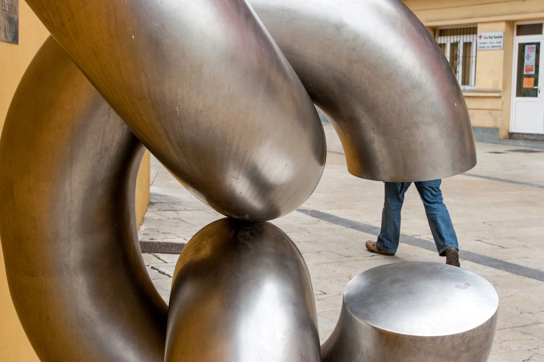 A bustling public square with a towering, abstract kinetic weather sculpture. Public Art Installations